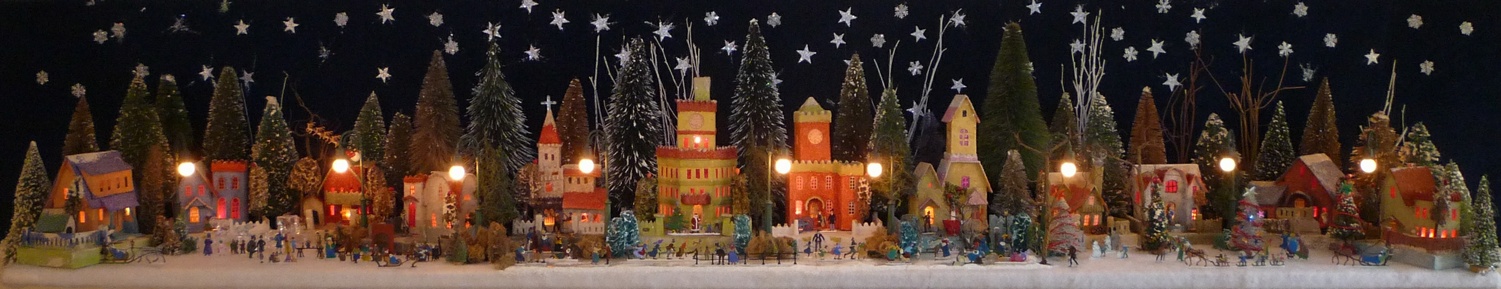 Antique Christmas cardboard house putz (village) on fireplace mantel at night (200K)